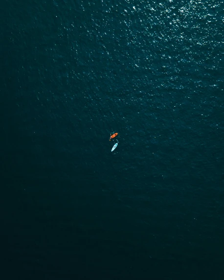 two people in a boat in an ocean