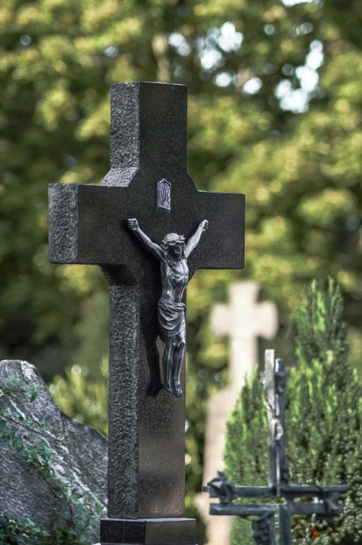 a statue of jesus on a cross at the cemetery