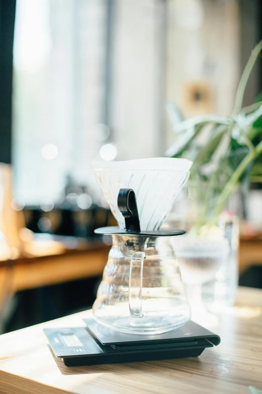 an indoor coffee maker set up on top of a wood table