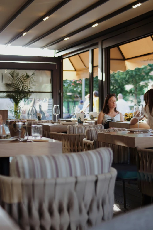 people dining at tables on top of a large porch