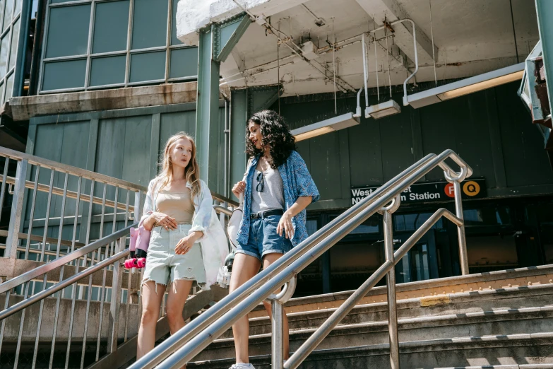 two people walking up a metal stair rail