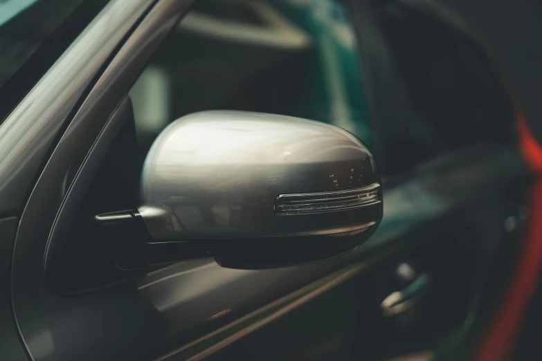 the side mirror of the vehicle is showing it's light on