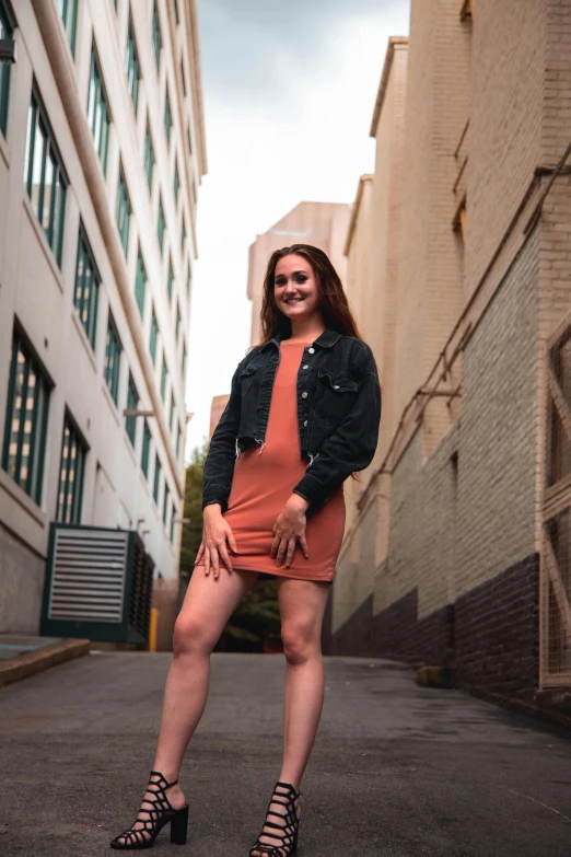 a woman in a red dress is standing in the middle of the street