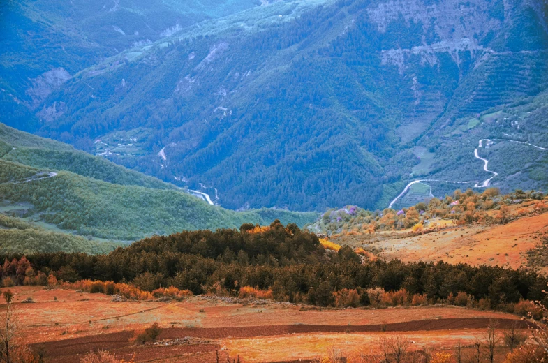 a road runs through a mountainous area that is empty and dry