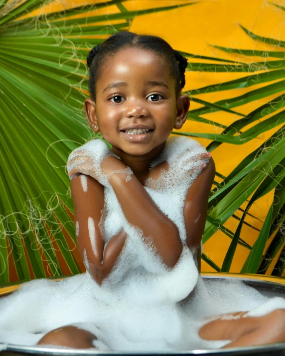 a young child is bathing with foam in the bathtub