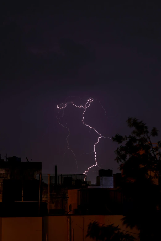 a bolt in the night sky and some buildings