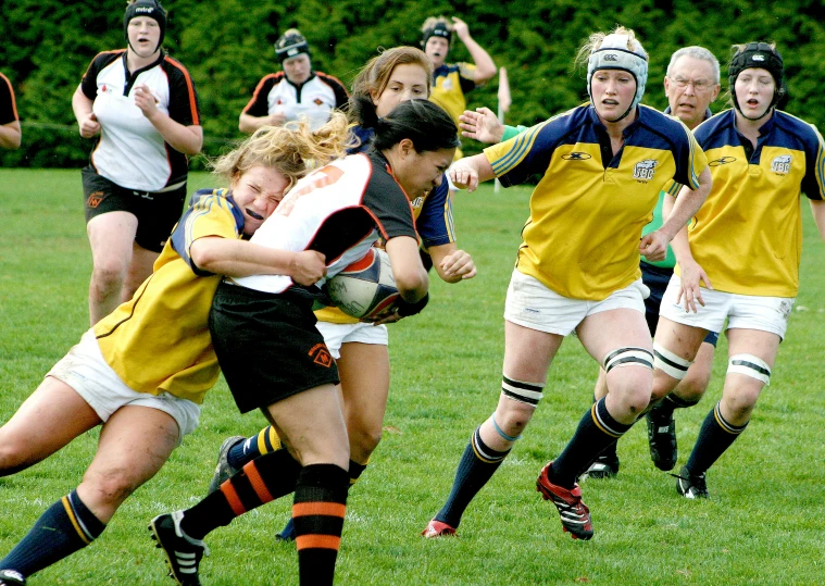 a couple of women are playing rugby together