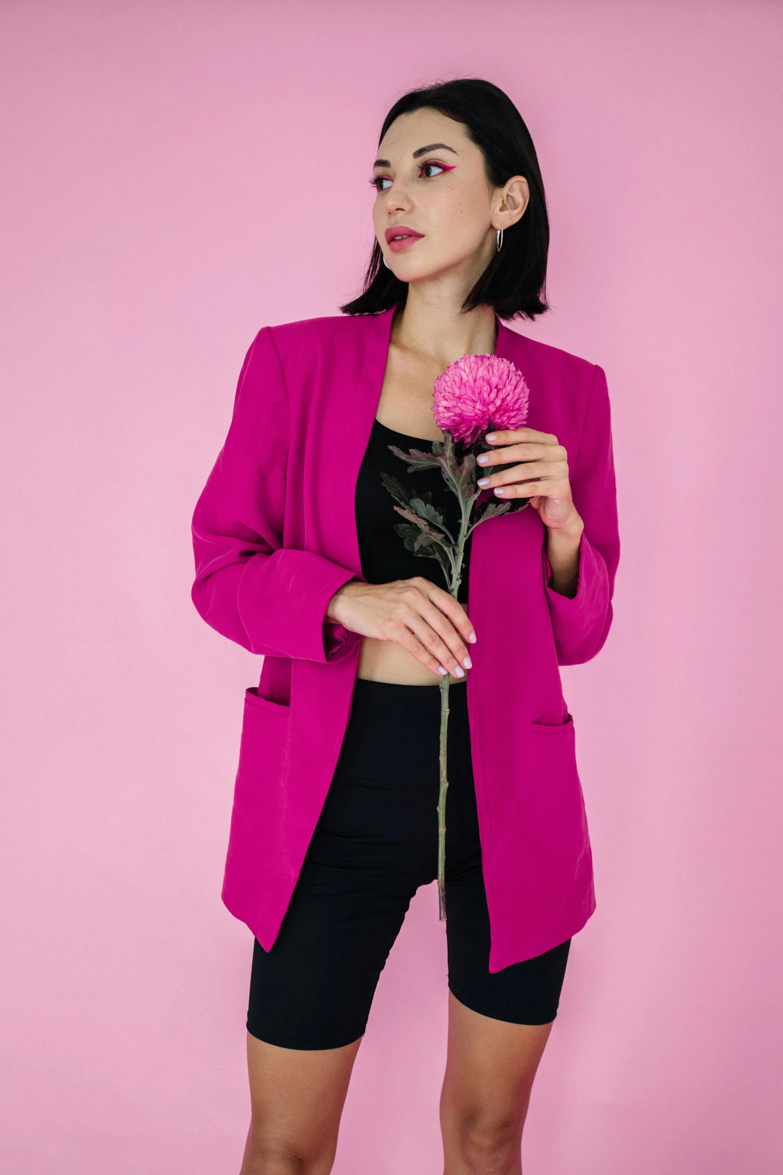 a woman posing while holding a rose