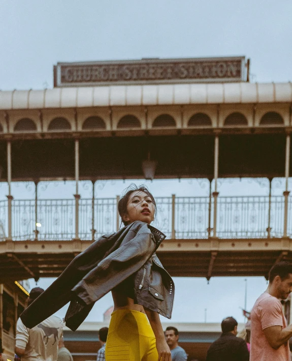 the woman is standing outside in front of a building