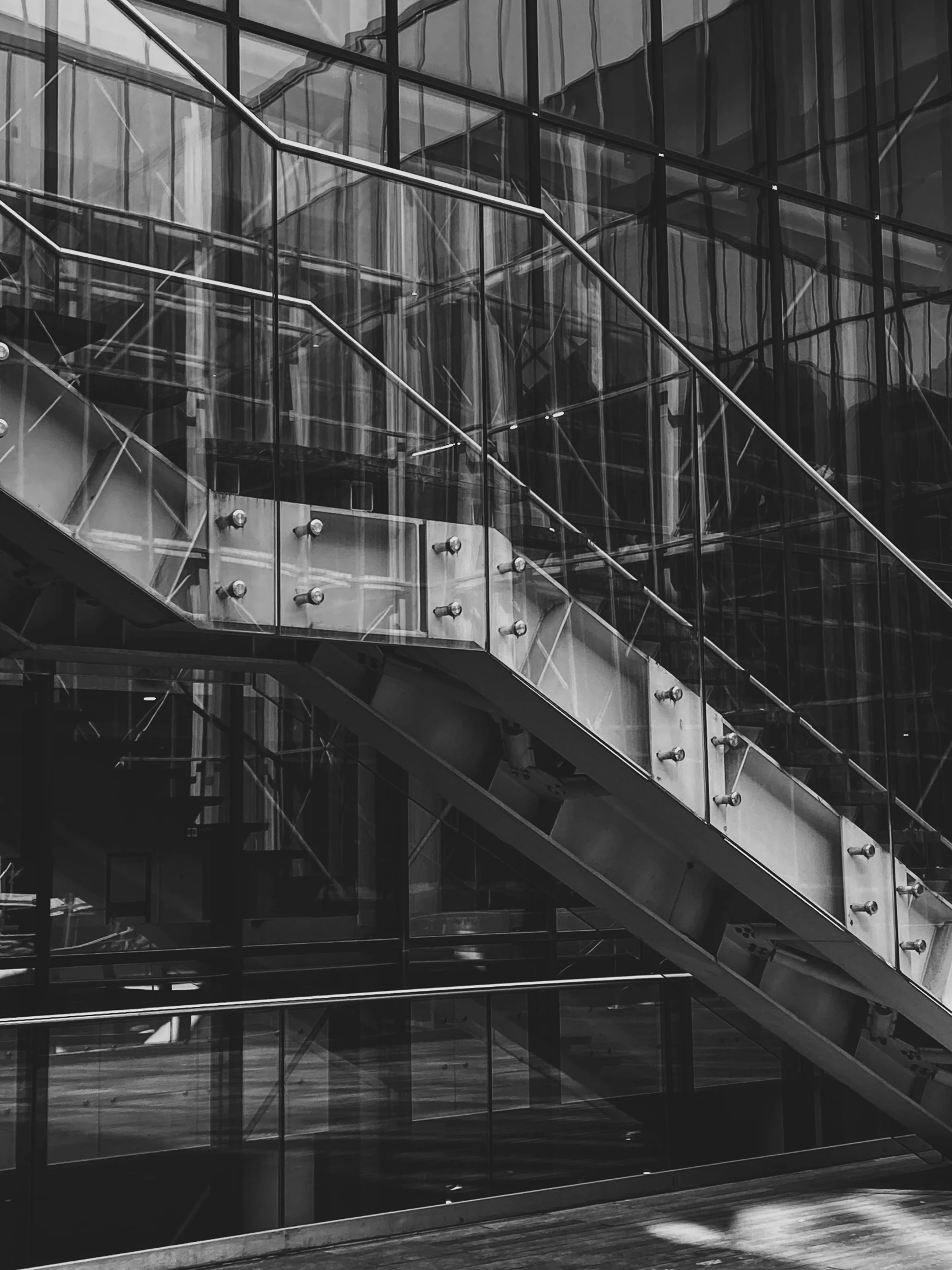 black and white image of the bottom of a stairwell in a building