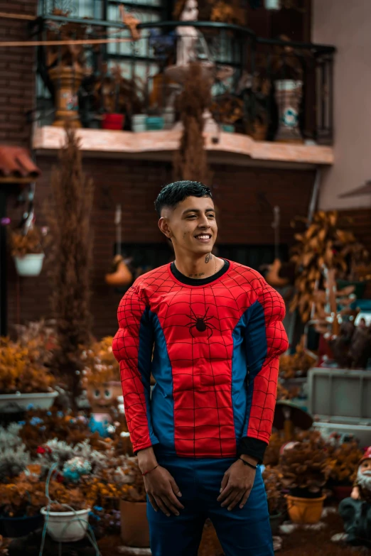 a young man wearing a spider suit posing for the camera