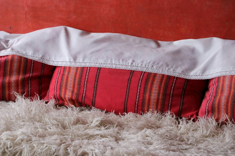 a bed with a pillow made from a blanket