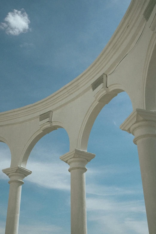 a bunch of white columns under a blue sky