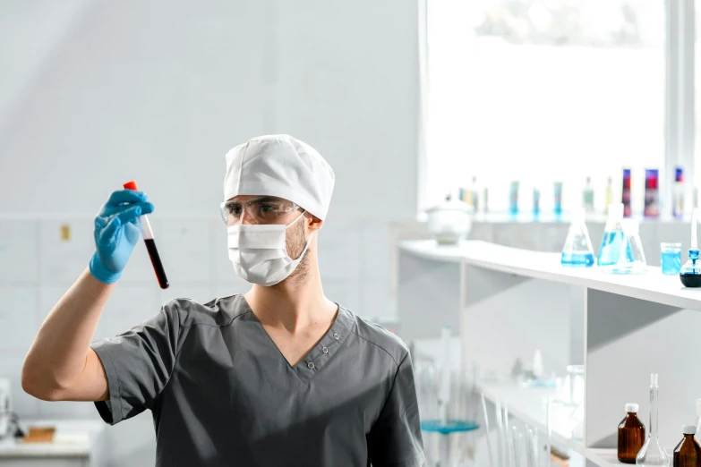 a man with a surgical mask is holding a pipe