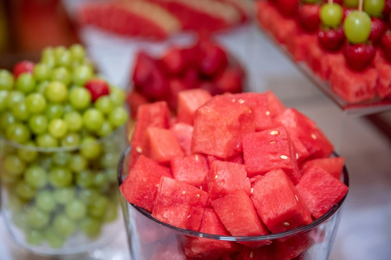 a bowl full of fresh fruit, gs and watermelon