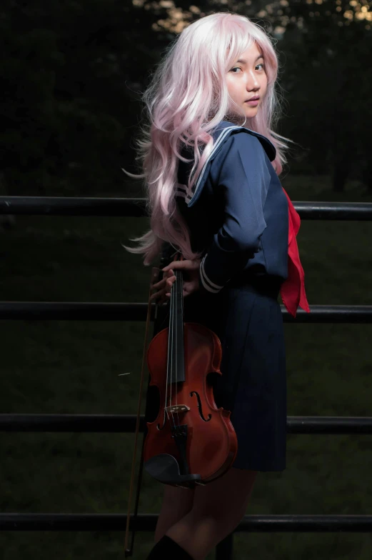 a girl with long blonde hair is holding a violin