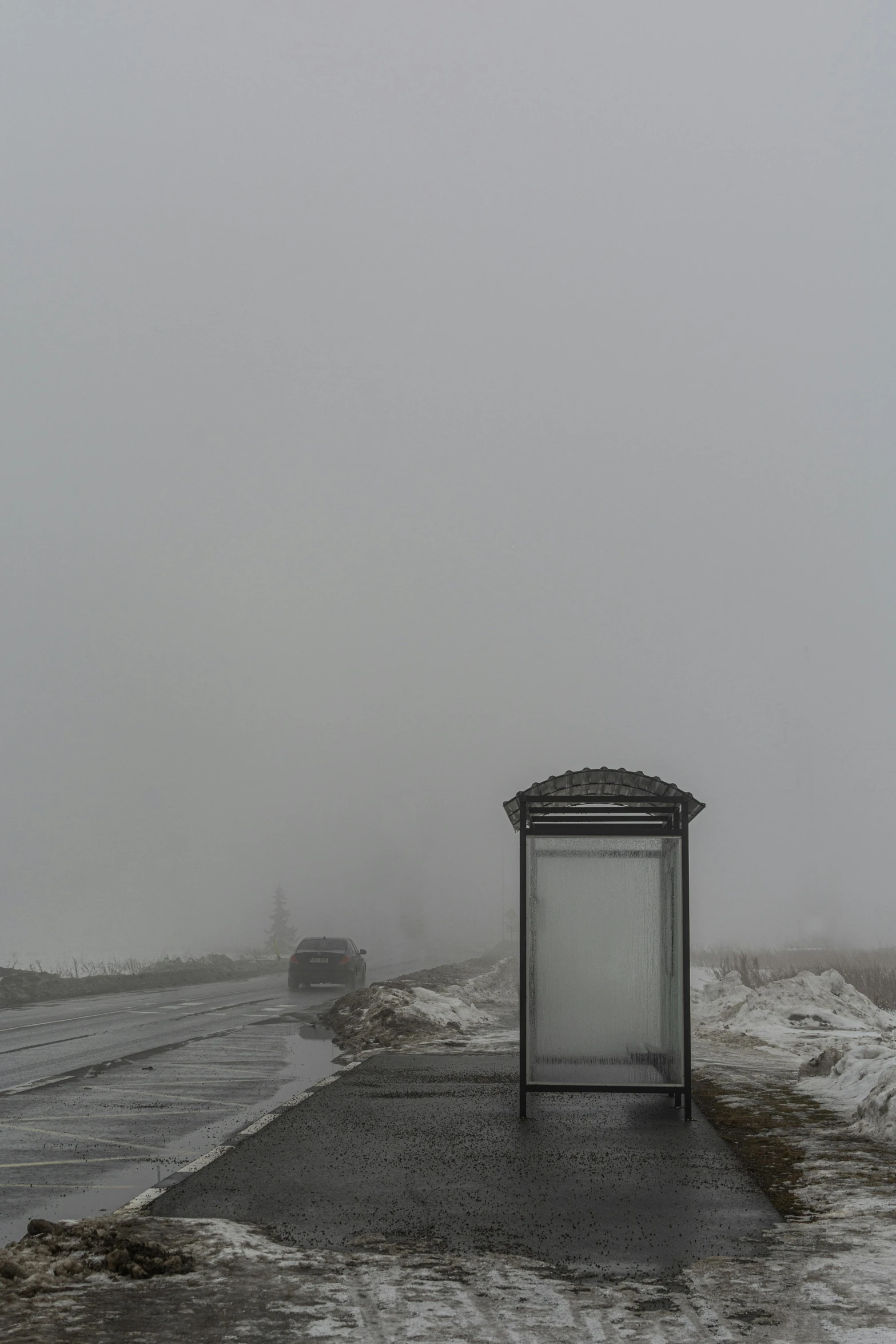 there is a bus stop on the side of the road