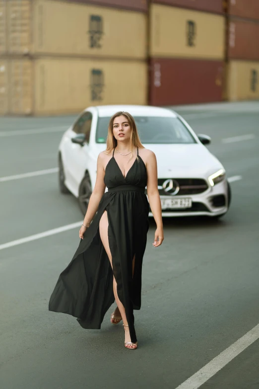 a woman with long legs is walking in the street