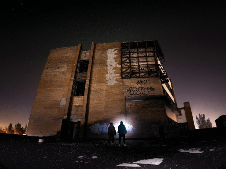 two people are standing outside a large building