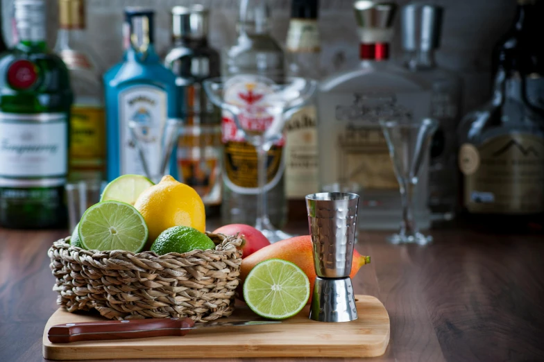 some oranges, limes, and other beverages sitting on a counter