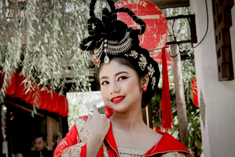 an asian woman in traditional dress poses for a picture