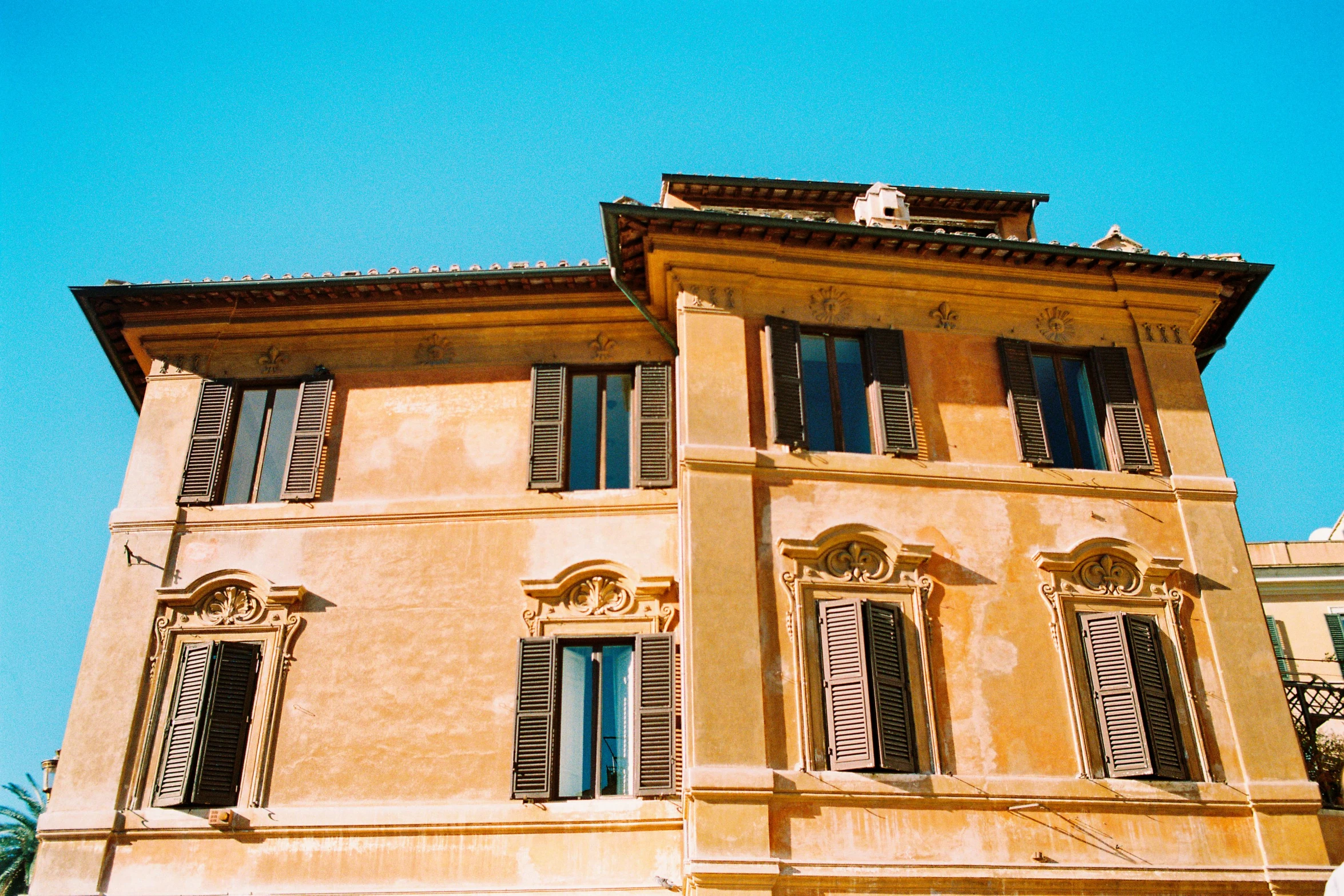 a yellow and red building with several windows