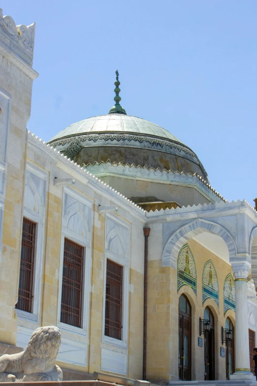 the entrance to a mosque with a statue on top