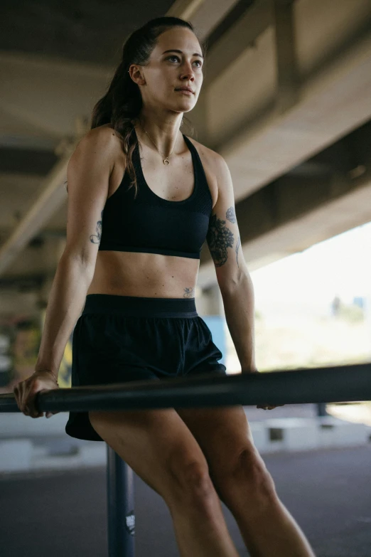 young woman doing pull - ups while exercising