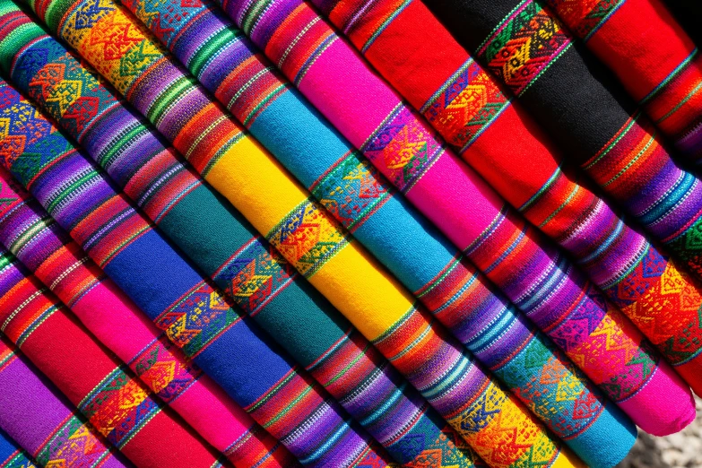 several colorfully colored textiles are stacked together