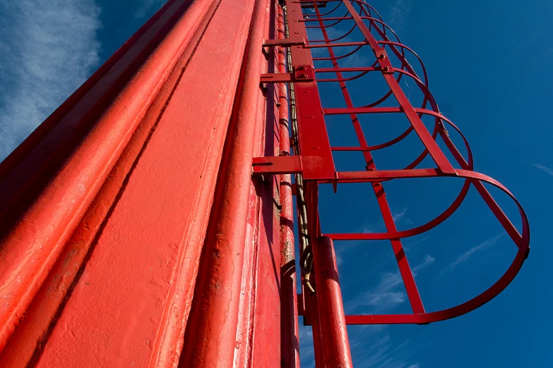 a red metal pole with an odd shaped handle