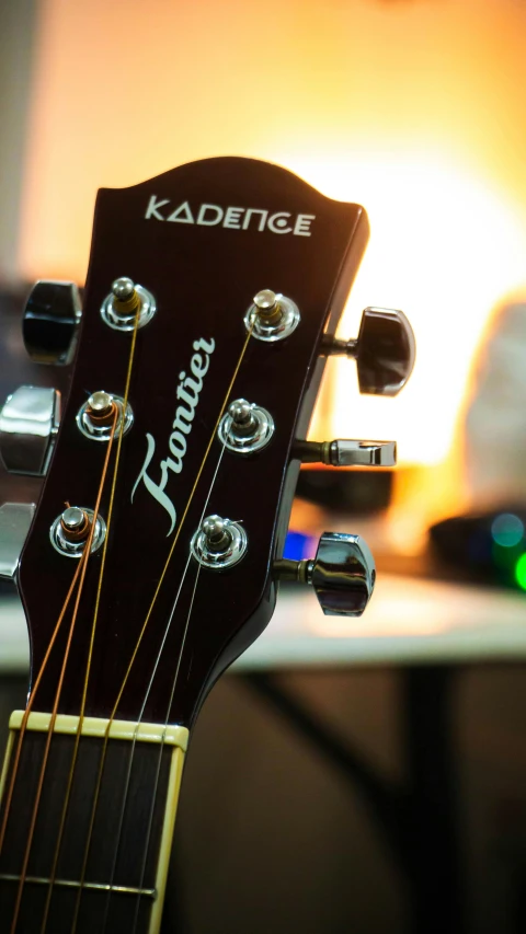 a close up of a guitar, with a blurry background