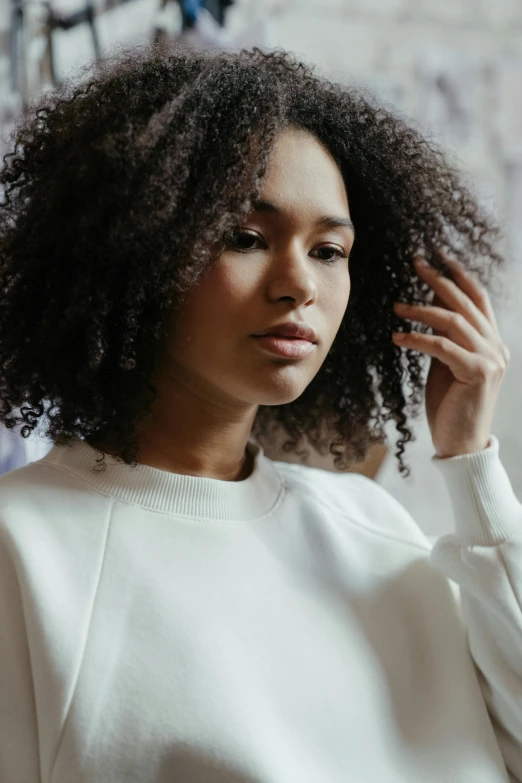 a black woman with a curly, afro hairstyle looking at the camera