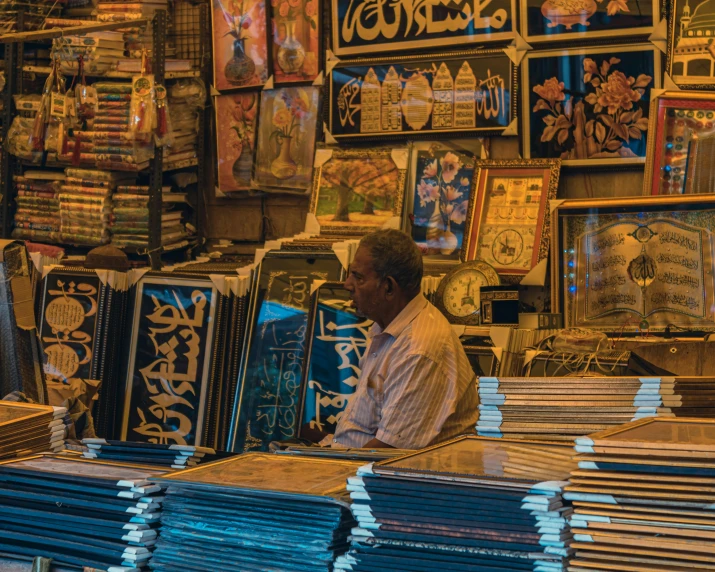 an elderly man working at a shop selling different types of clocks