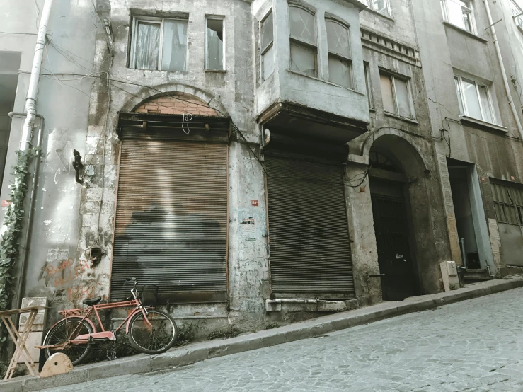 an alleyway with a bike parked near a garage door