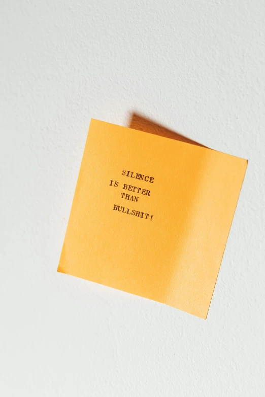 a small yellow piece of paper with writing