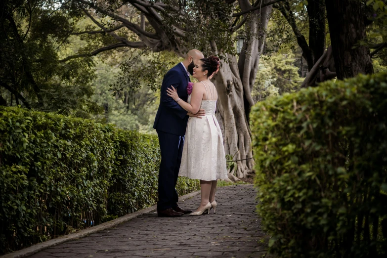 there are two people kissing under trees