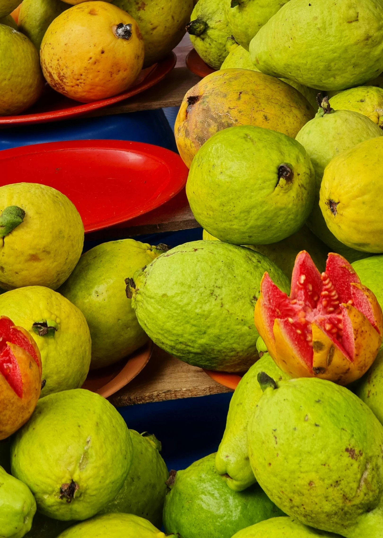 different fruits in bowls with yellow ones and green ones