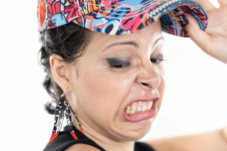 a woman holding her head up while wearing a bandana