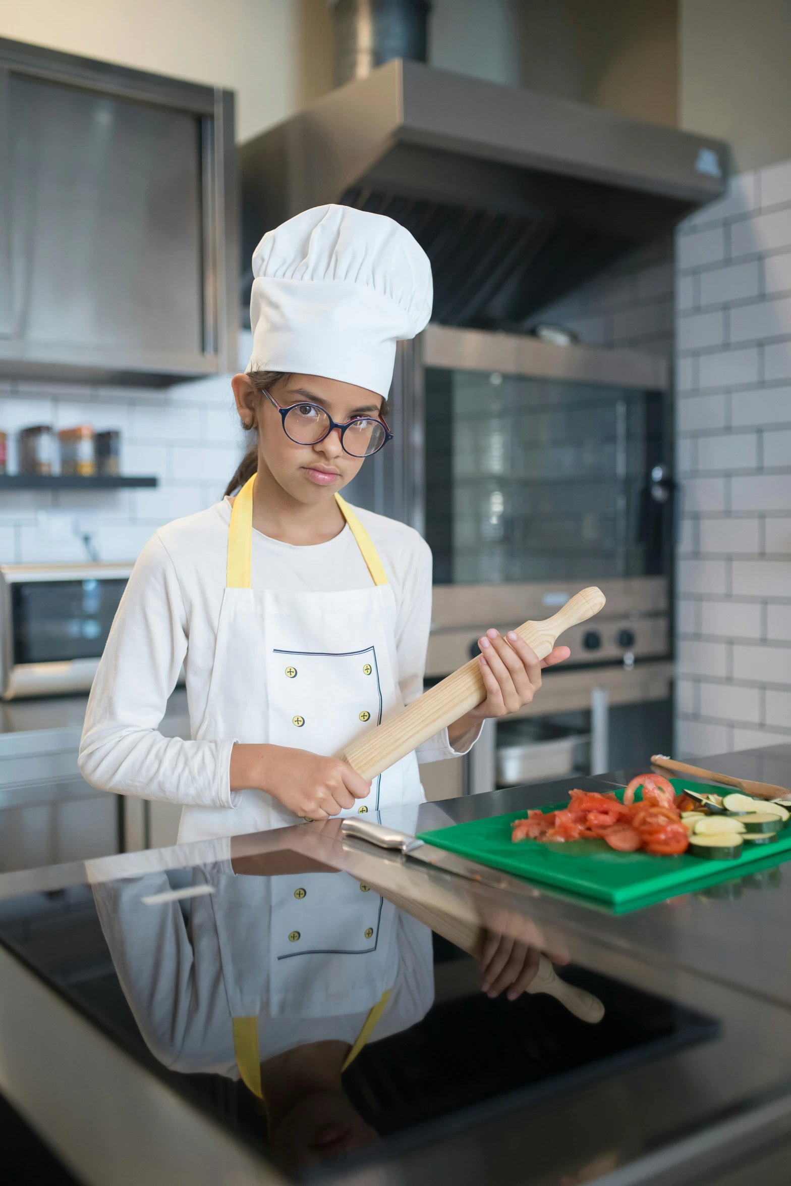 a woman wearing glasses and an apron making food