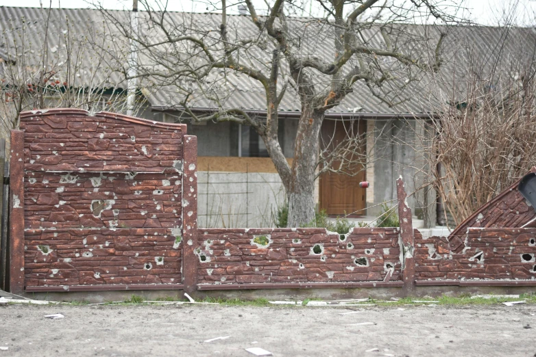 the motorcycle is parked near an old, broken brick building