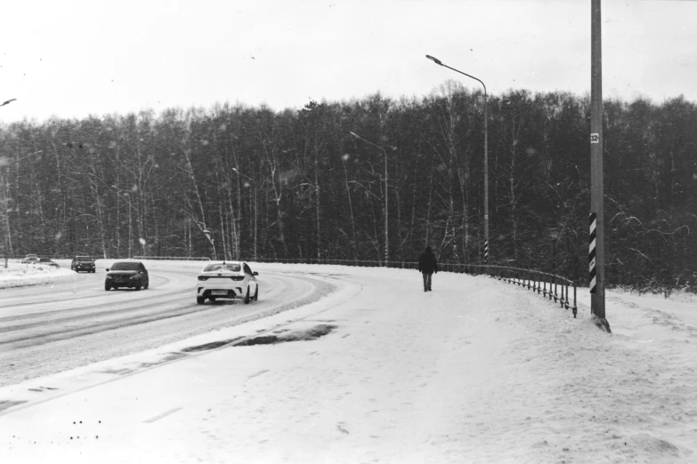 a person walking down the street on a snowy day