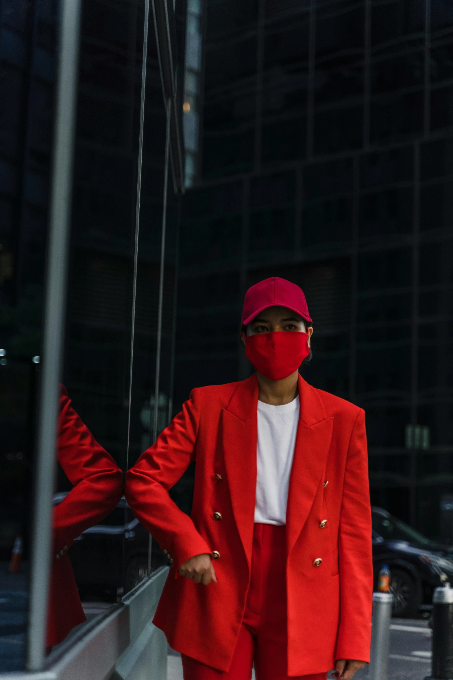 a person in red blazer and mask on the street