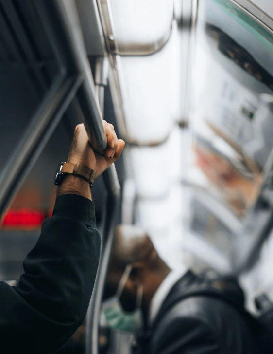 someone is looking in a vehicle and has a wristwatch