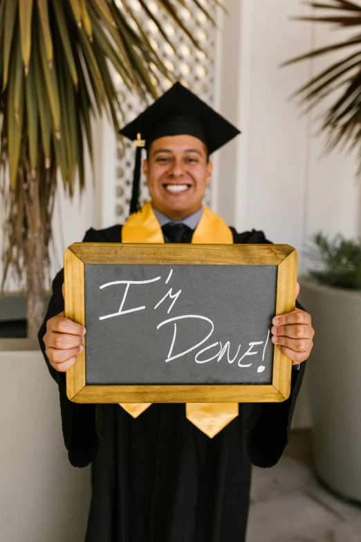 a man is holding a blackboard that says i'm done