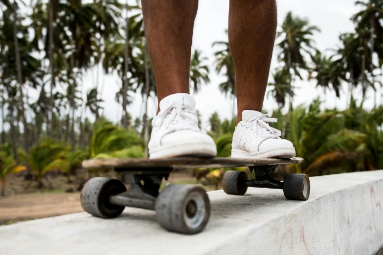 a person is standing with their feet on a skateboard