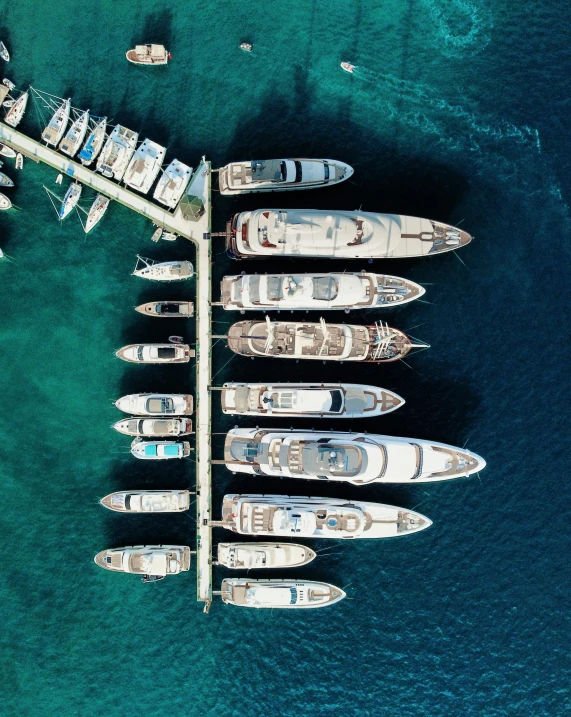 the large group of yachts are parked close together in the water