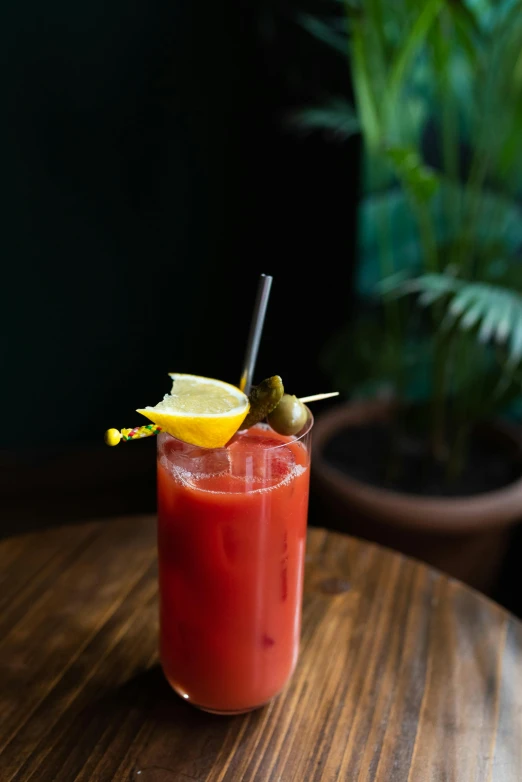 a large glass on a table with a drink