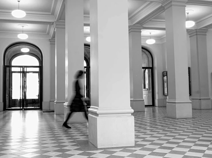 the black and white po is a man in a hallway