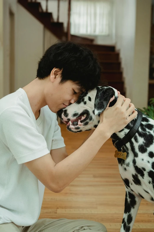 a person sitting down next to a dog