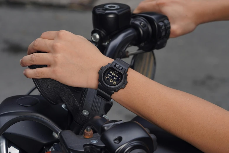 a watch sits on the handlebar of a motorcycle